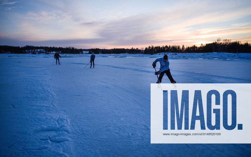 January 22, 2022, West River, PEI, CANADA Ryan Sanderson, front, plays a game of shinny with