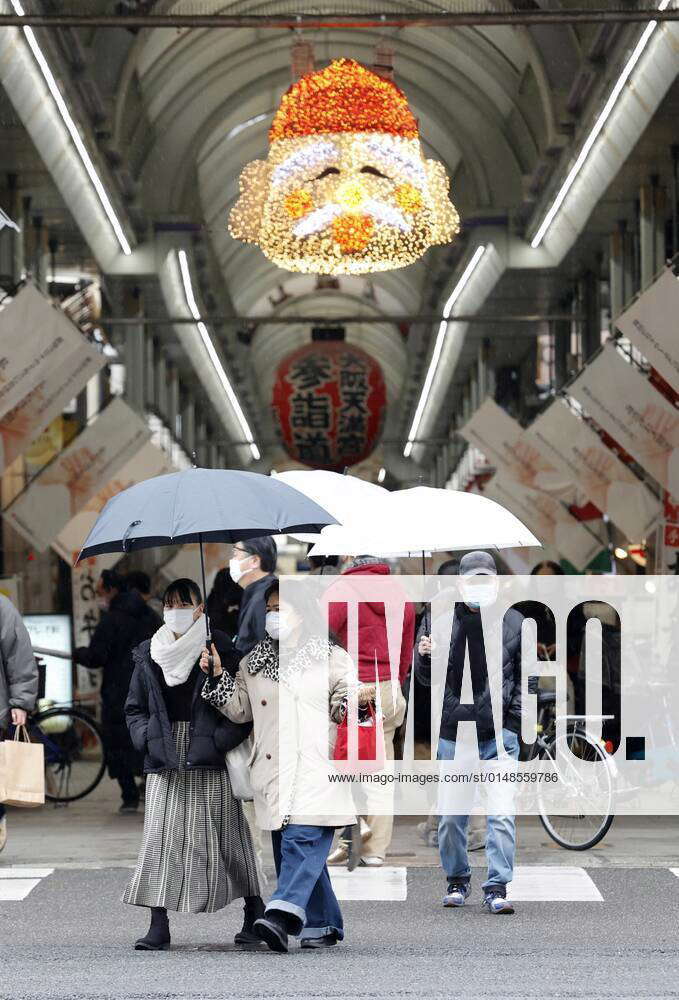 Osaka amid coronavirus pandemic People wearing masks walk along a