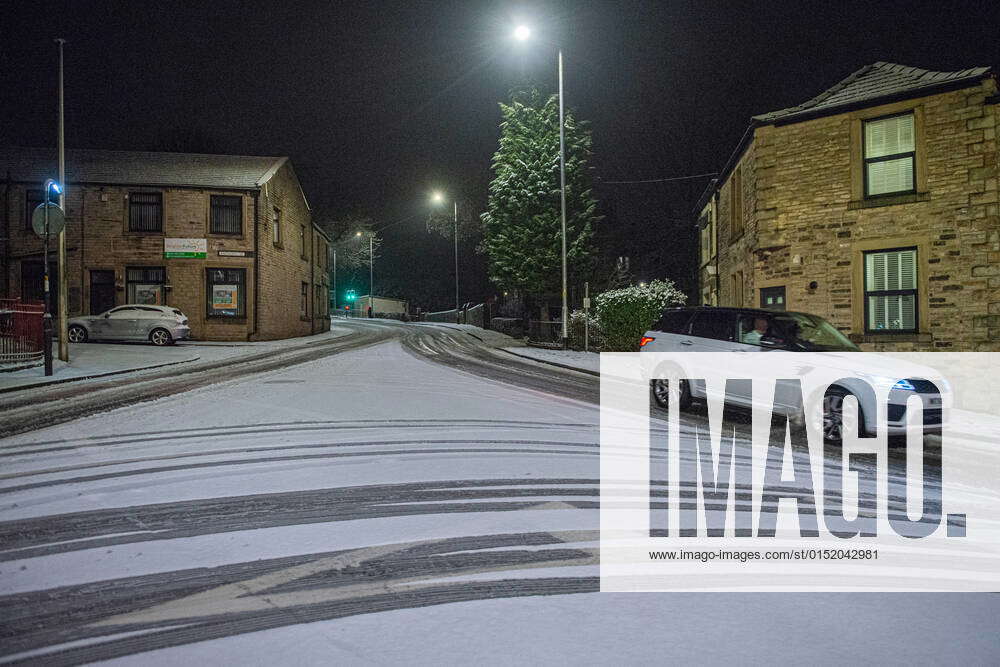 A car makes it s way through ice on the A670 Stamford Street in Mossley