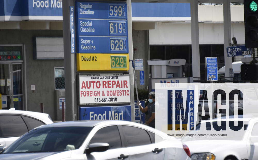 Gas Prices Continue To Rise As A Gas Station Attendant Changes The ...