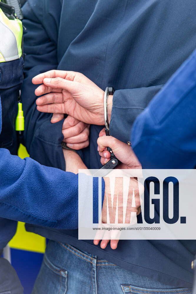 illustration-image-shows-a-person-being-put-in-handcuffs-during-a-photo