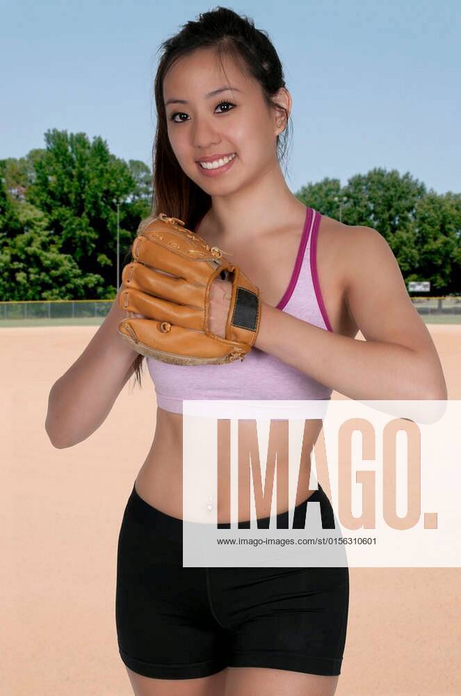 Beautiful woman baseball pitcher getting ready to throw a ball in a