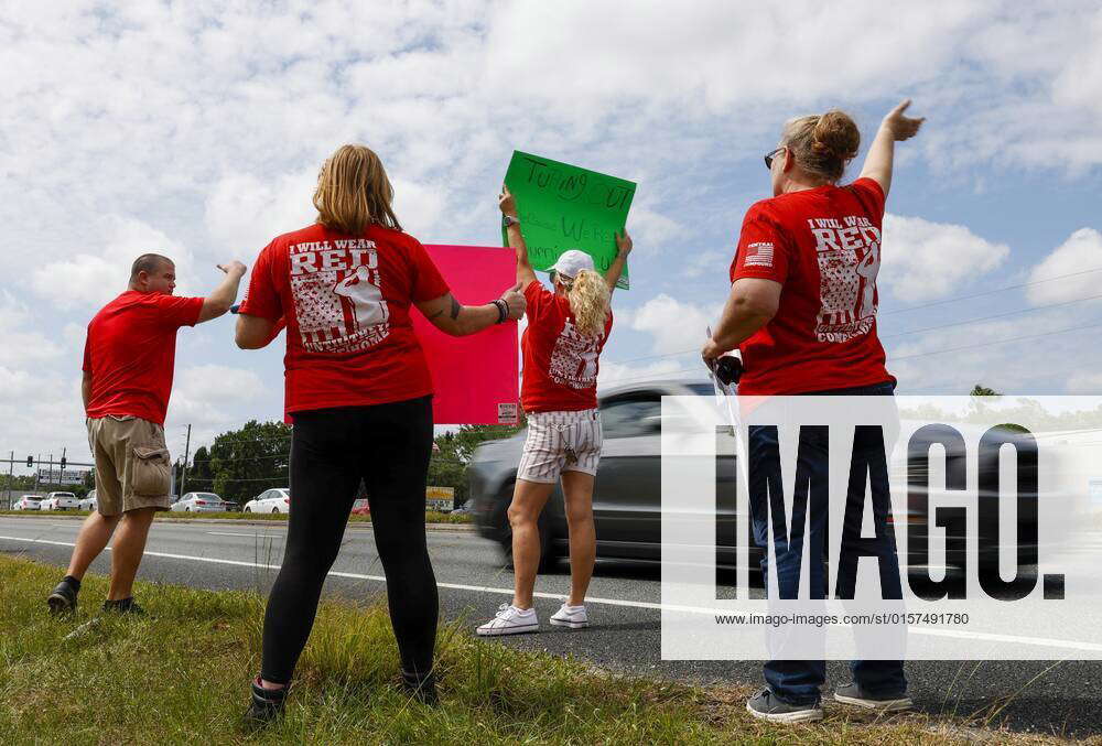 April 29, 2022, Land O Lakes, Florida, USA Pasco County Schools bus drivers wave and hold signs