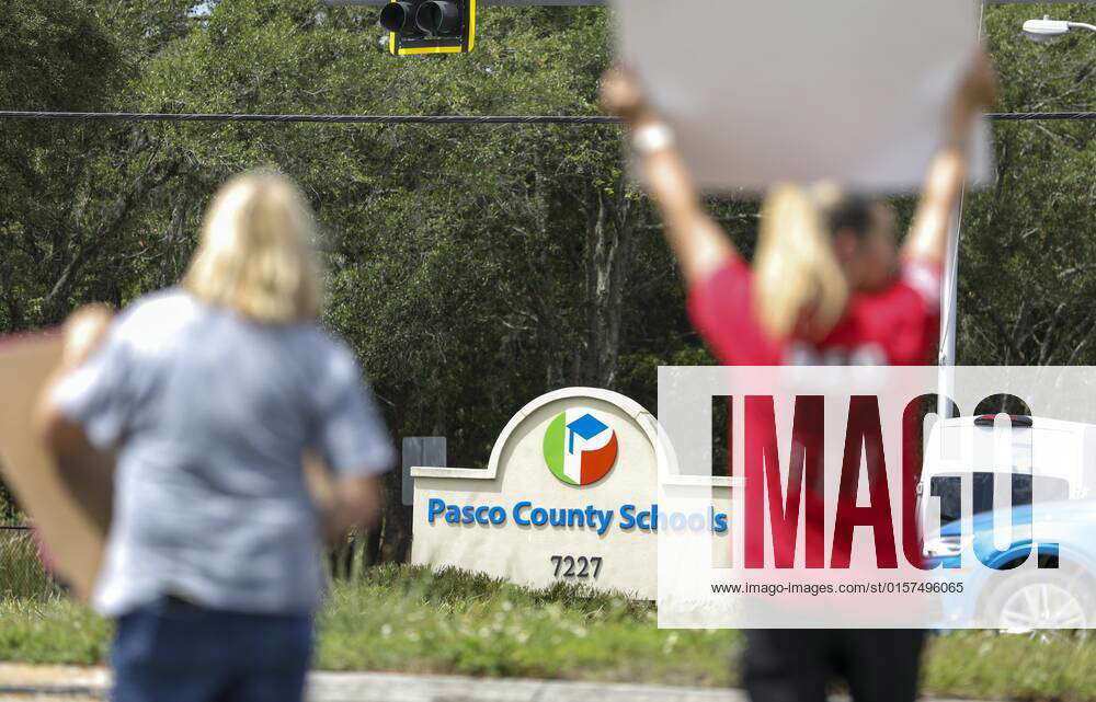 April 29, 2022, Land O Lakes, Florida, USA Pasco County Schools bus drivers wave and hold signs