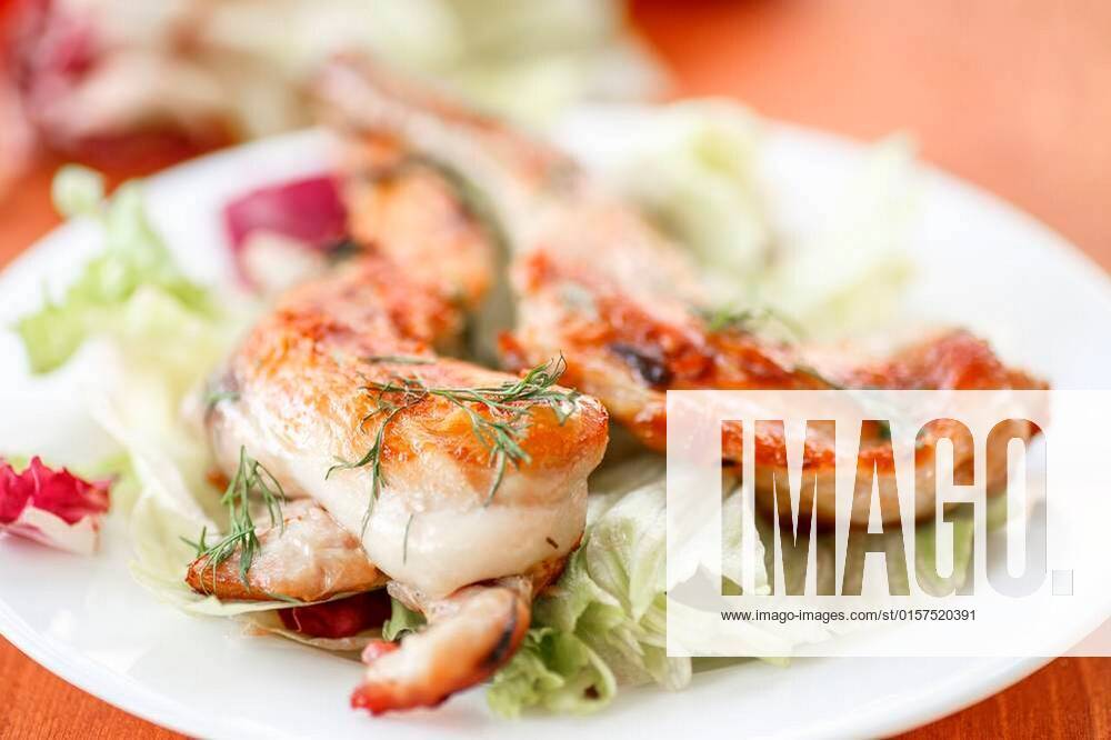 Roasted rabbit leg on fresh lettuce leaves xFotosearchxLBRFx xrawlikx