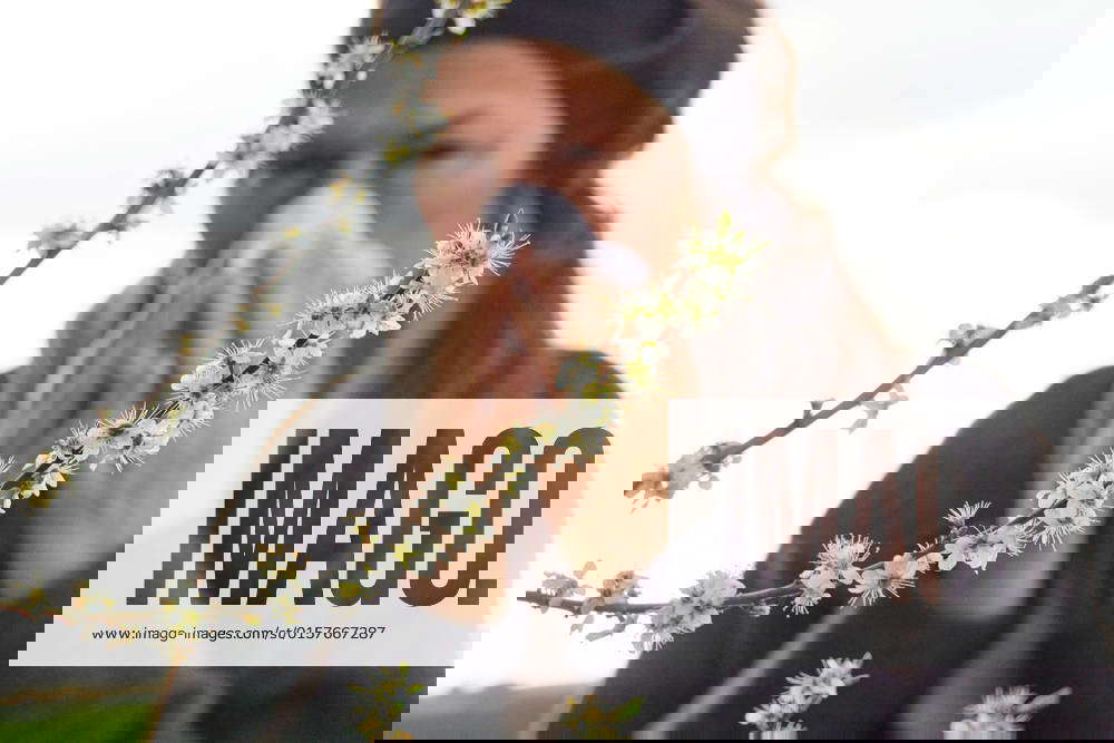 Woman has allergy symptoms, burning eyes and blows her nose in