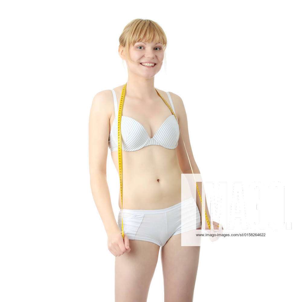 Sexy, fit, young,blond woman in underwear measuring her body