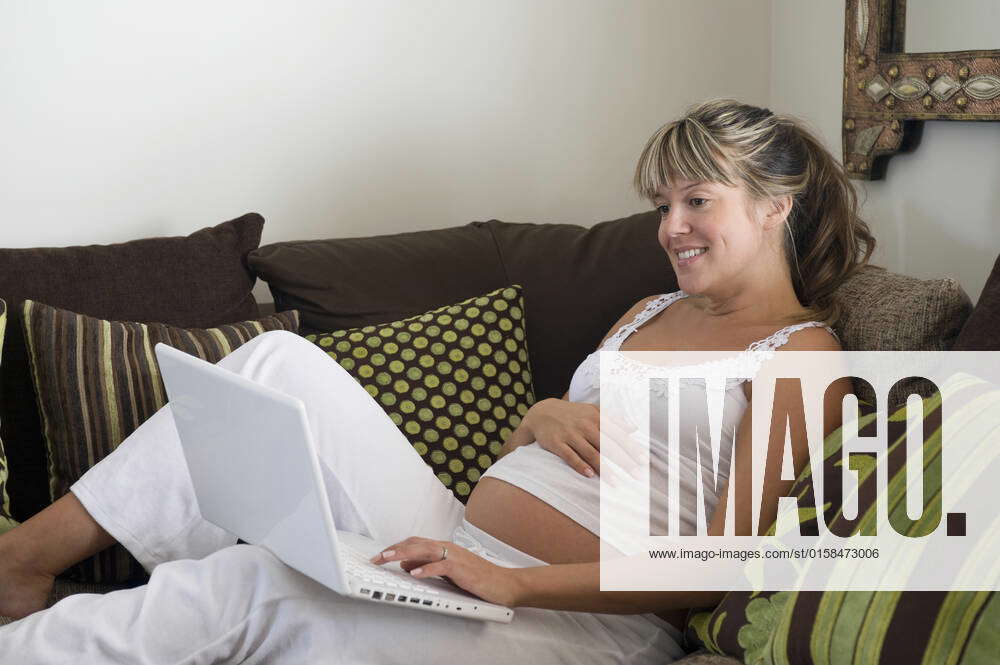 Pregnant Woman Reclining On Sofa With Laptop Model Released Property Released 1817