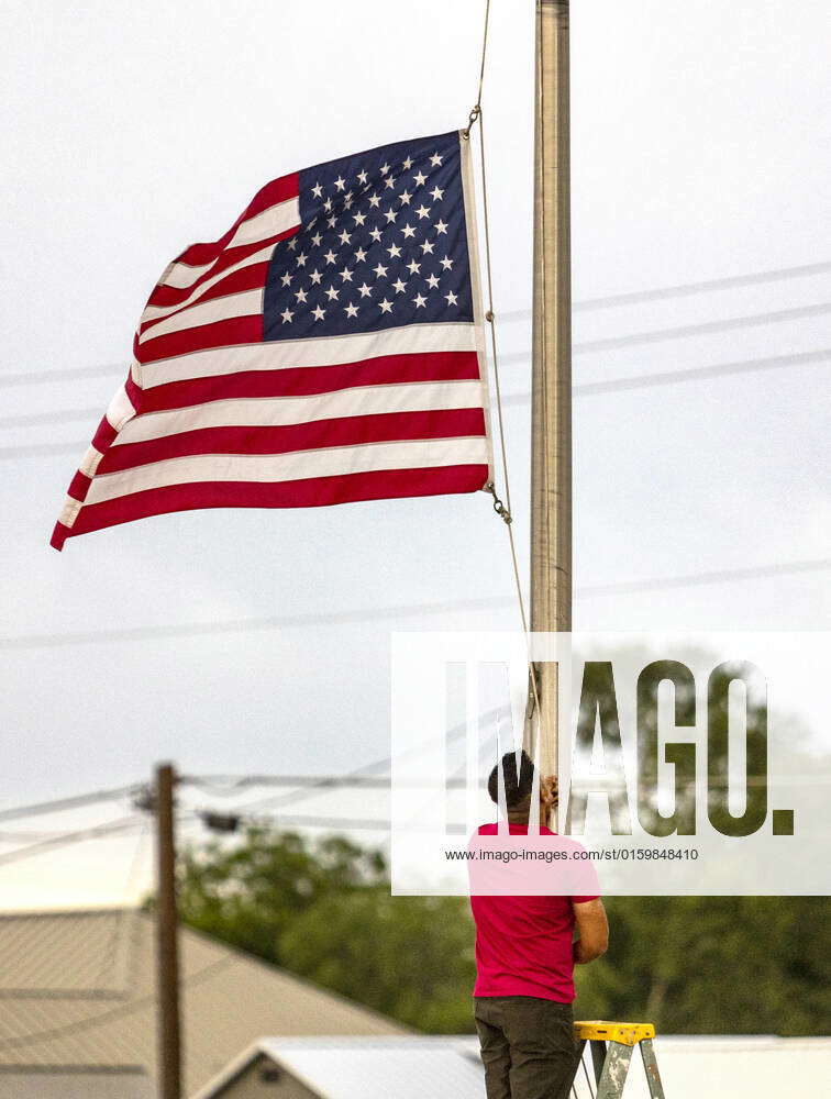 May 24, 2022, Uvalde, Texas, USA Janish Patel lowers the flag to half