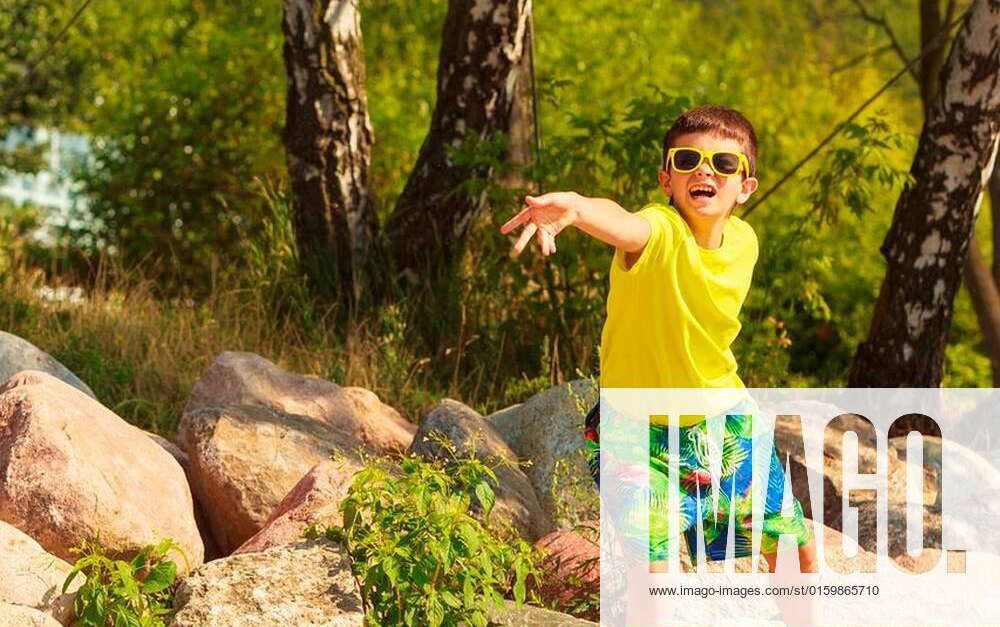 Play and fun concept. Little playful enjoyable boy kid throwing frisbee