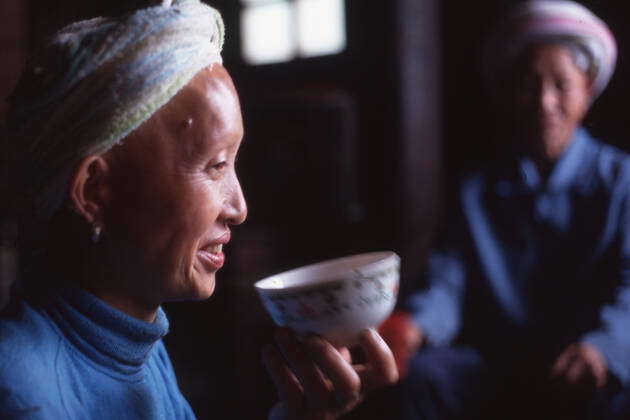 July 1 1997, China: Woman drinking from a small bowl. The Laotian ( Lao ...