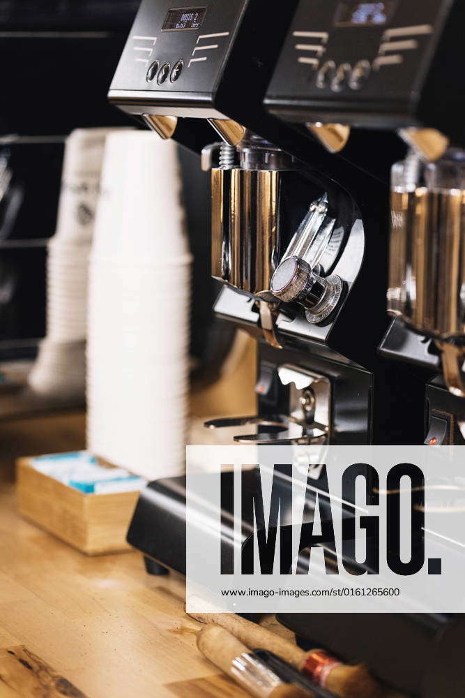 Contemporary black coffee makers with chrome details placed on wooden