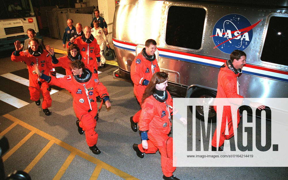 The STS-96 crew smile and wave at onlookers as they eagerly head for ...