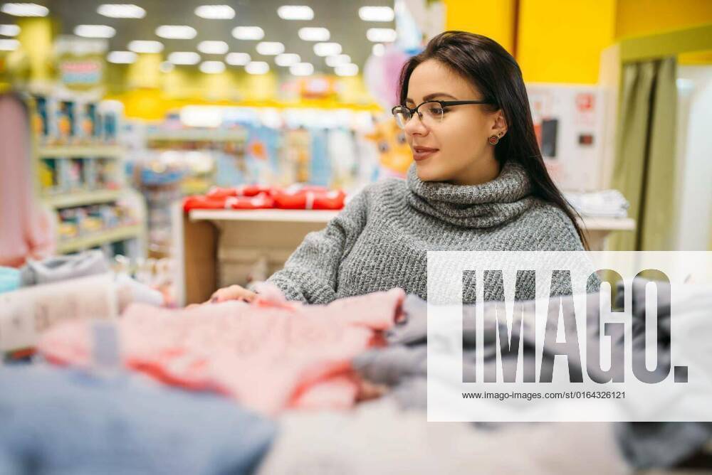 Future mother in glasses buys childrens clothes, Cheerful future mother(02)