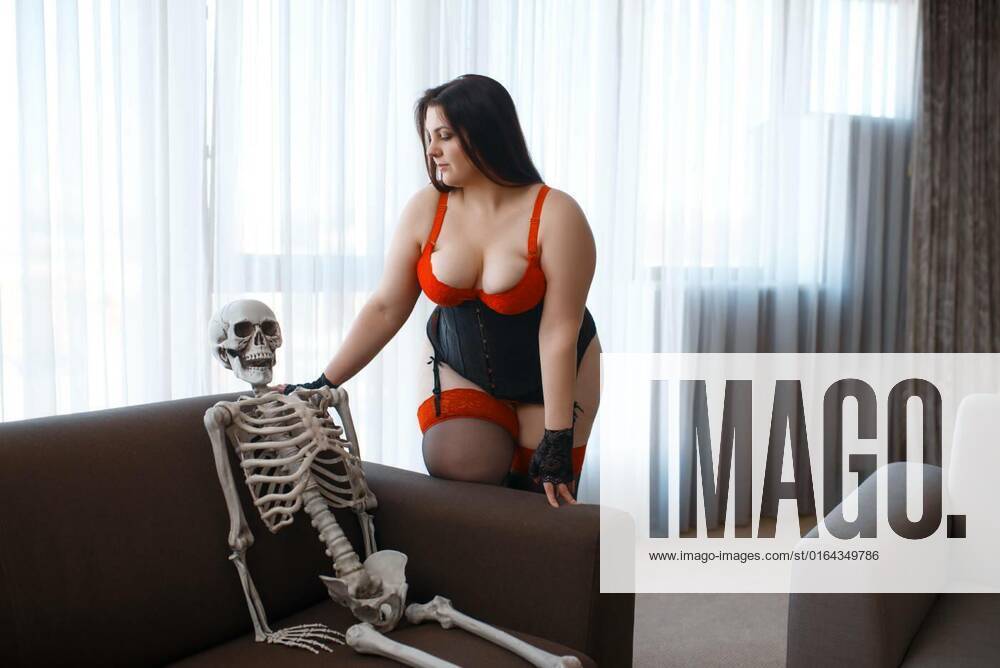 Overweight woman and skeleton are sits on couch Overweight woman