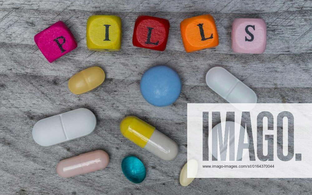 Pills letter cubes and tablets on gray wood concept, Pills letter cubes