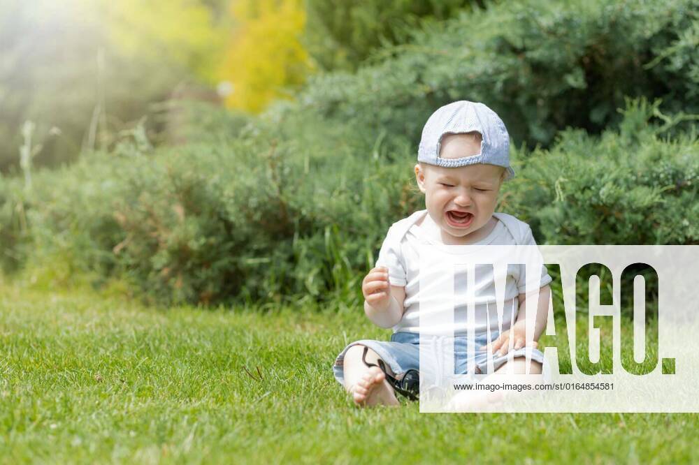 little-baby-boy-is-crying-sitting-on-the-grass-little-baby-boy-is