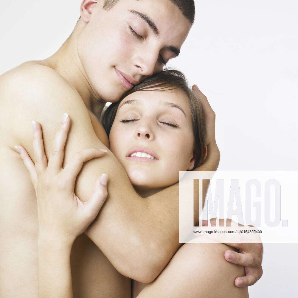 A young nude couple embracing