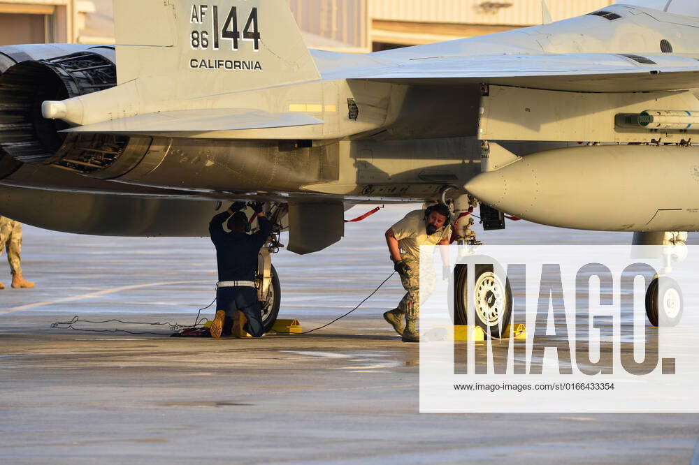 Crew chiefs from the 144th Fighter Wing prepare a F-15C Eagle fighter ...