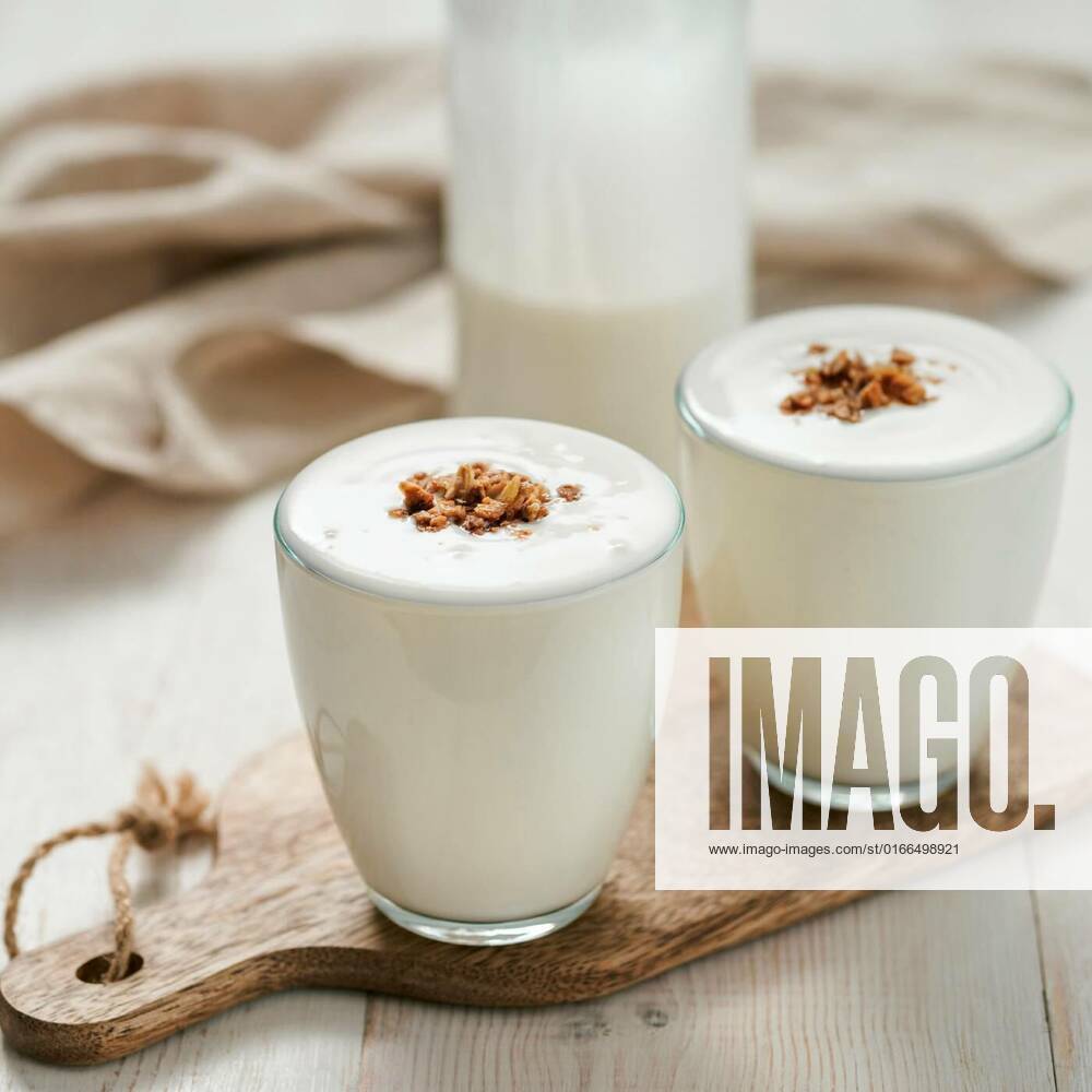 Gut health, fermented products concept, Kefir, buttermilk or yogurt with granola. Yogurt in glass