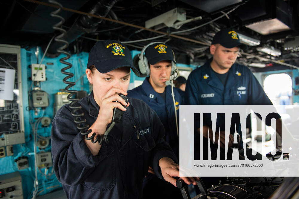 YOKOSUKA, Japan (June 18, 2013) Fireman Ashley Jett, left, relays ...