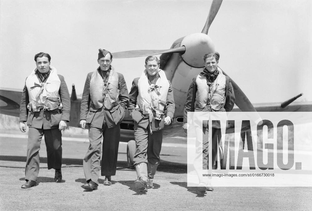 Pilots of No. 611 Squadron walk away from a Supermarine Spitfire Mk V ...