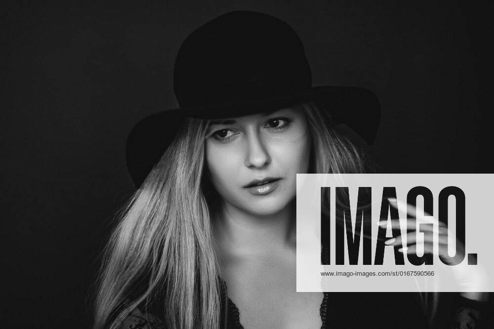 Beautiful Blonde Woman Wearing A Hat Artistic Film Portrait In Black