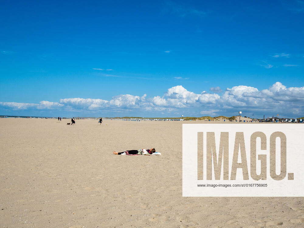 People Enjoying The Good Weather At The Hook Of Holland. A woman is