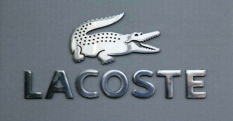 Company logo of Lacoste company emblem crocodile brand name trade business luxury brand