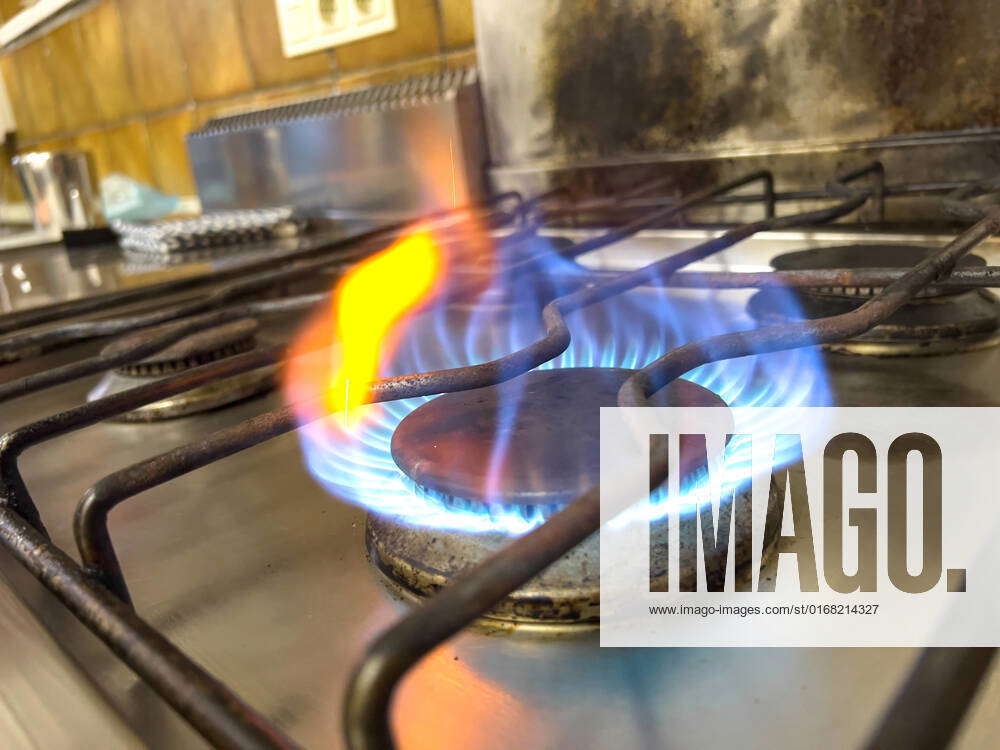 A person ignites a gas stove with a lighter in Marktoberdorf, Bavaria