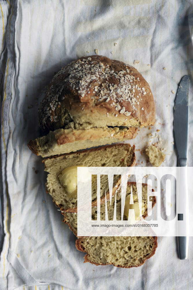 Soda bread without yeast half sliced ona cotton white tea towel