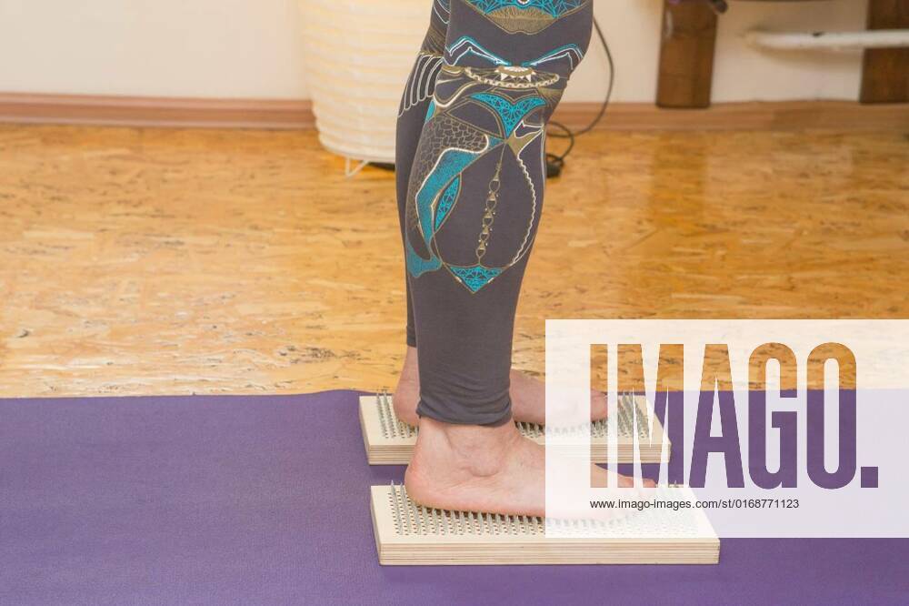 Practice of standing on nails. Closeup of a yoga man standing on a