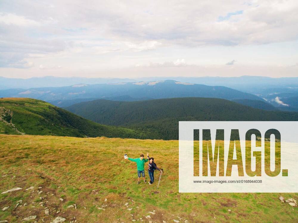 Aerial view of the Great Green Ridge. Guy and Girl Standing on a Big