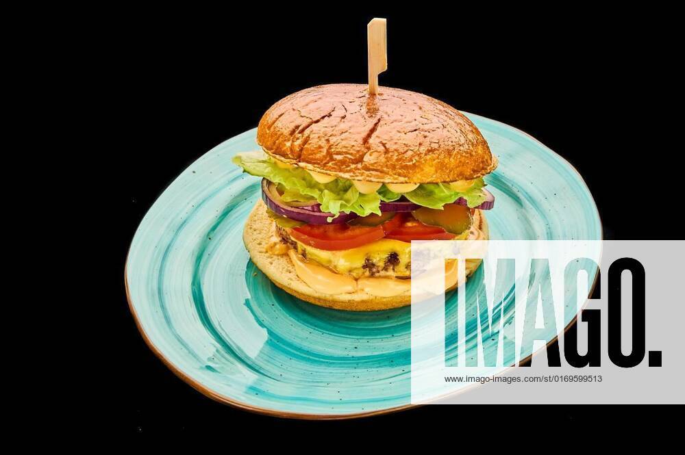 American cheeseburger isolated on a black background, american