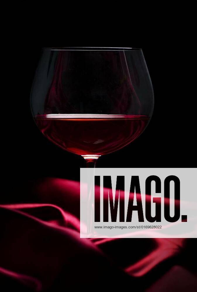 glass-of-wine-on-red-silk-glass-of-red-wine-on-red-silk-against-black