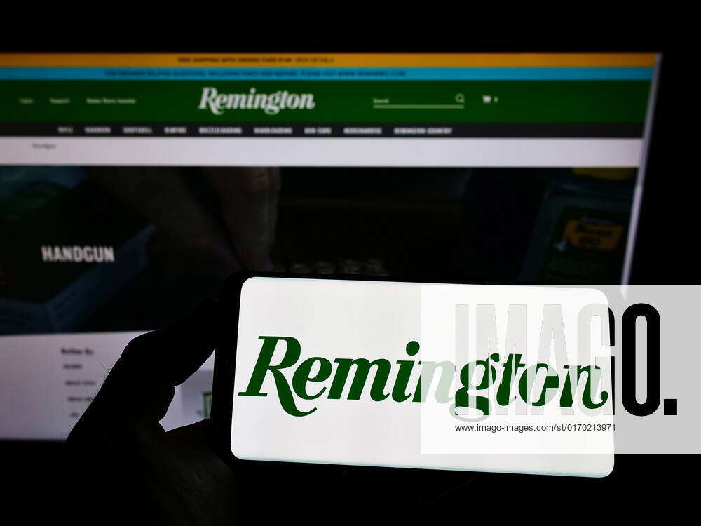 Person holding mobile phone with logo of American company RemArms LLC