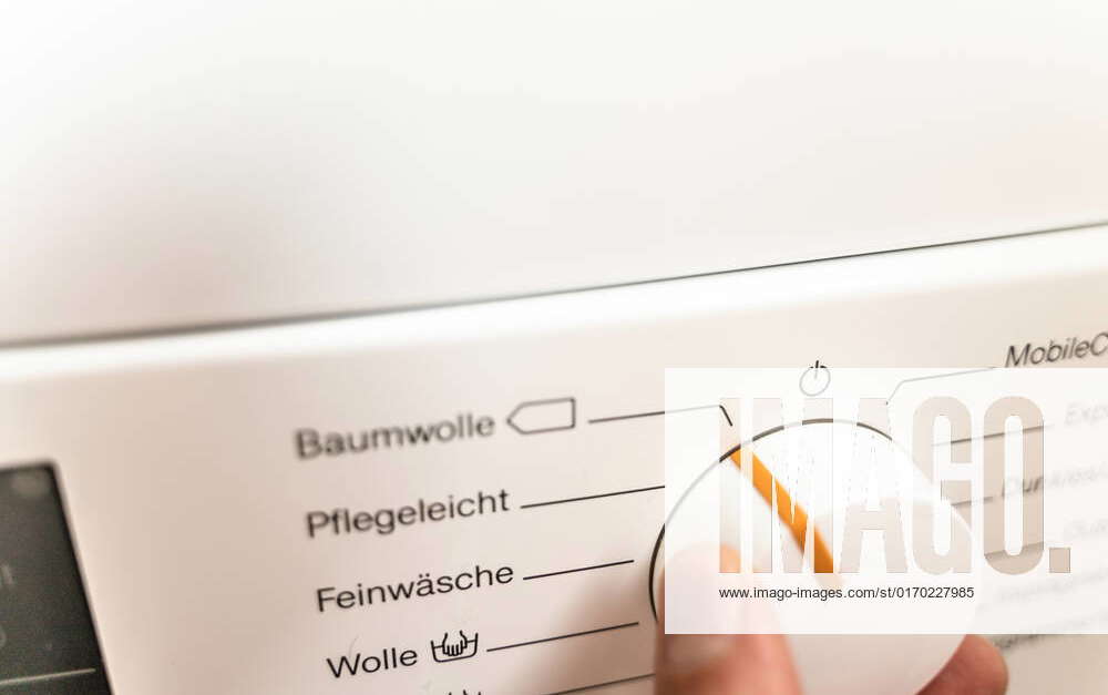 25 September 2022 Hand of a man selecting a washing program for a