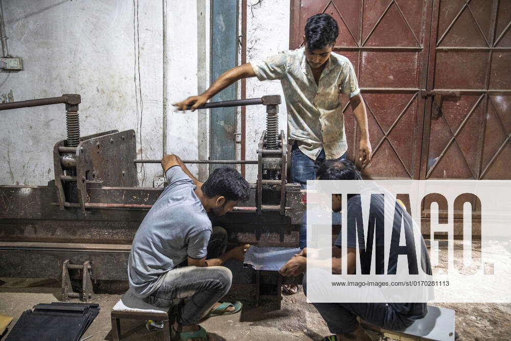 Furniture Factory In Bangladesh Workers prepare metal frame for