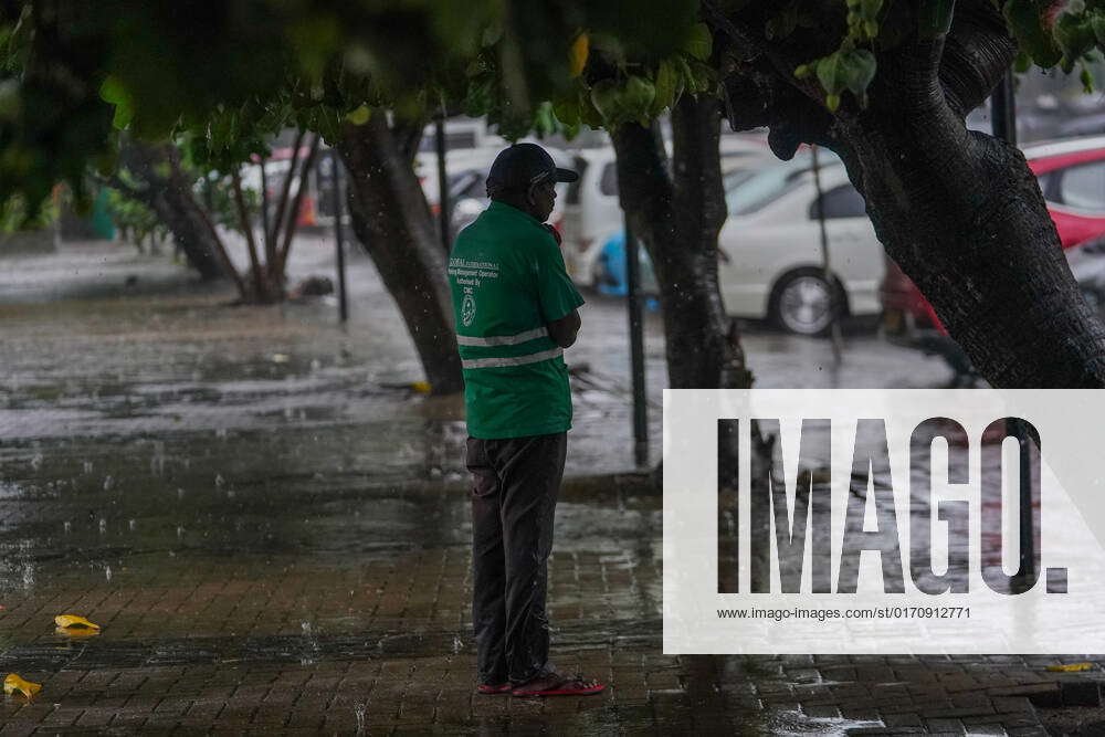 Heavy Rain In Sri Lanka A man in the rain in Colombo, Sri Lanka on The ...