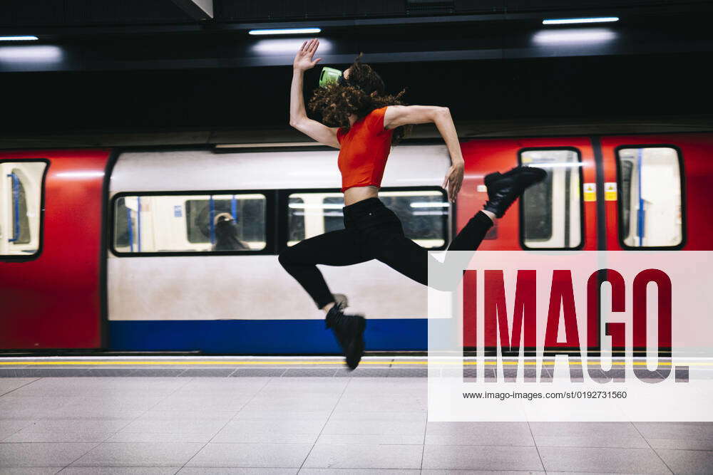 Woman jumping in front of train at subway station model released