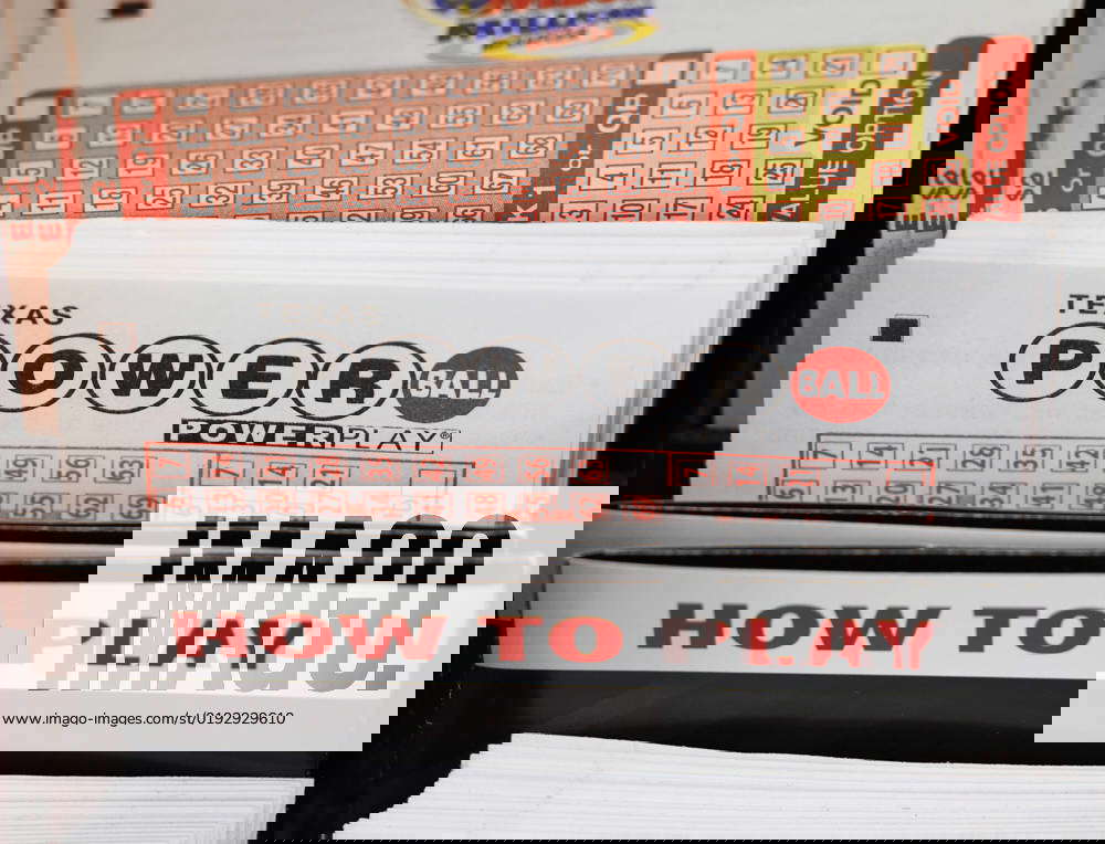 Powerball lottery ticket cards are on a rack at a gas station in