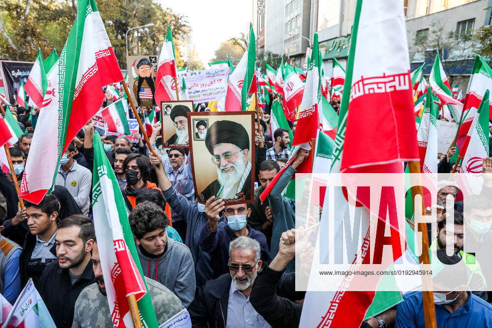 Pro-government supporters wave their national flags as some of them ...