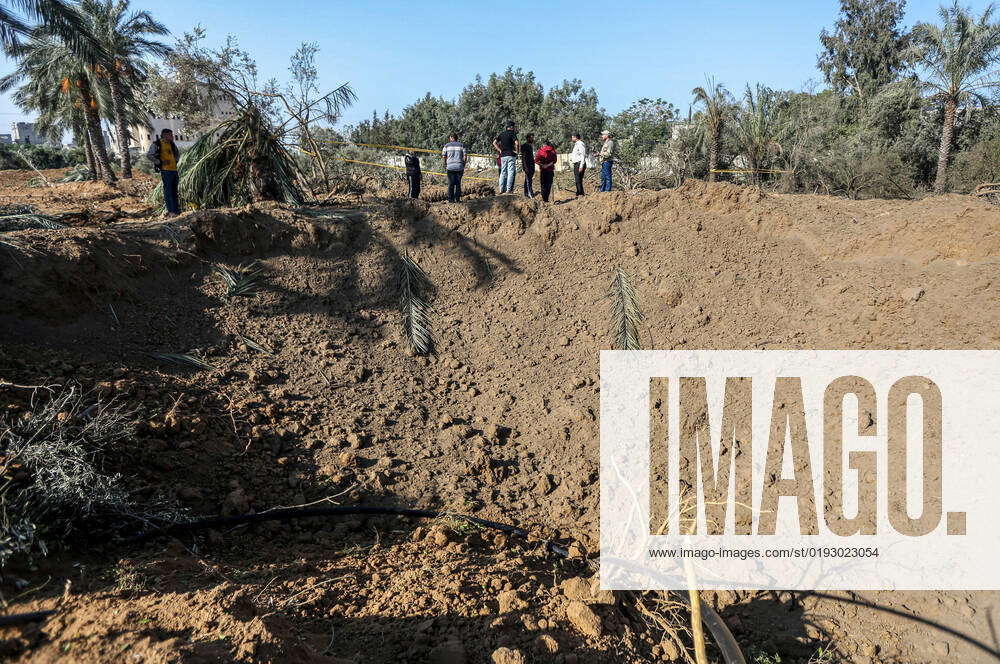 November 4, 2022, Gaza, Palestine: Palestinians stand next to a crater ...