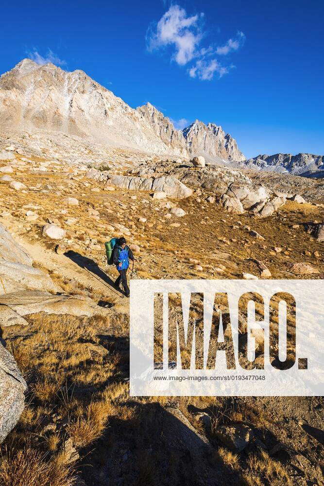 Backpacker crossing Bishop Pass, Kings Canyon National Park, California ...