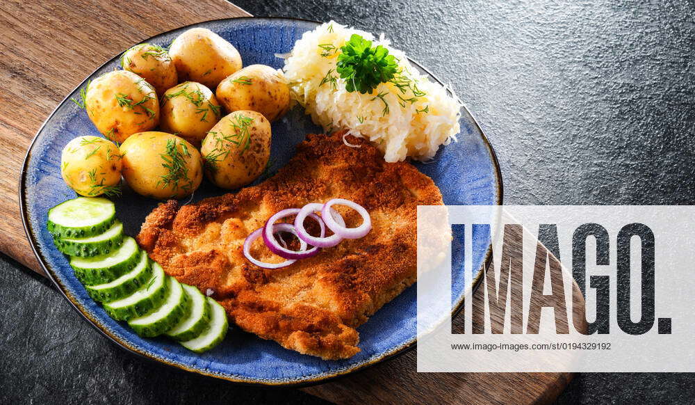 Pork breaded cutlet coated with breadcrumbs served with potatoes and ...