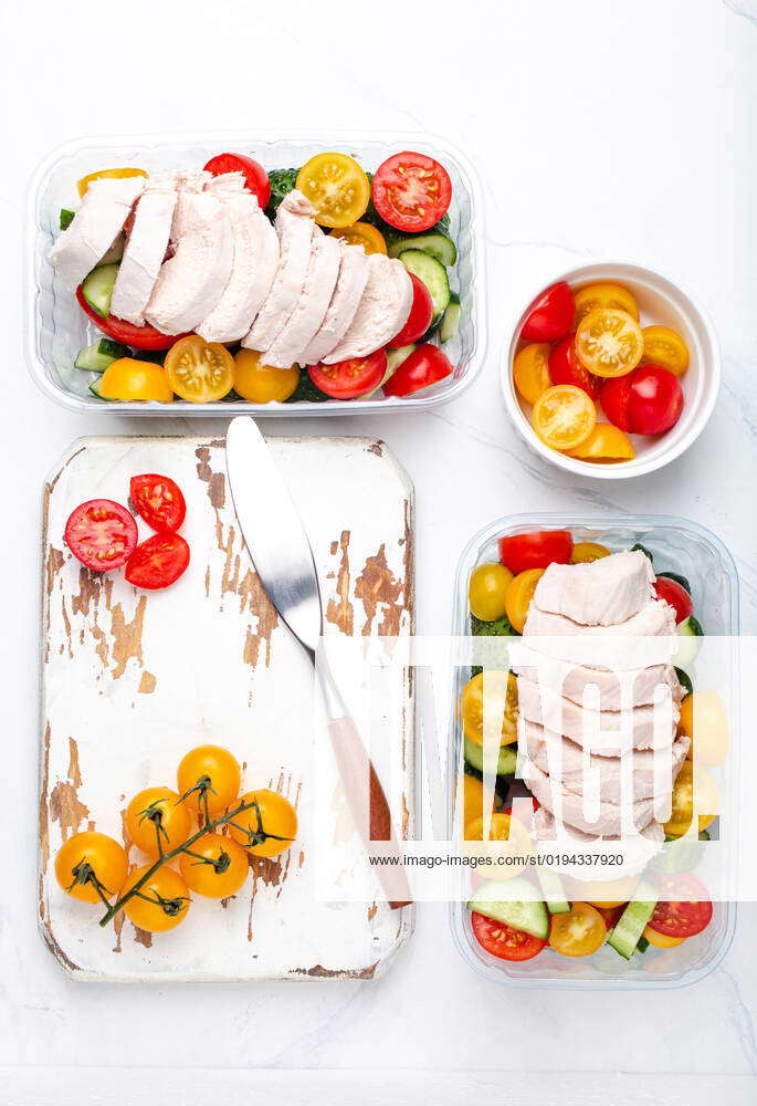 Meal prep lunch boxes containers with chicken and salad top view