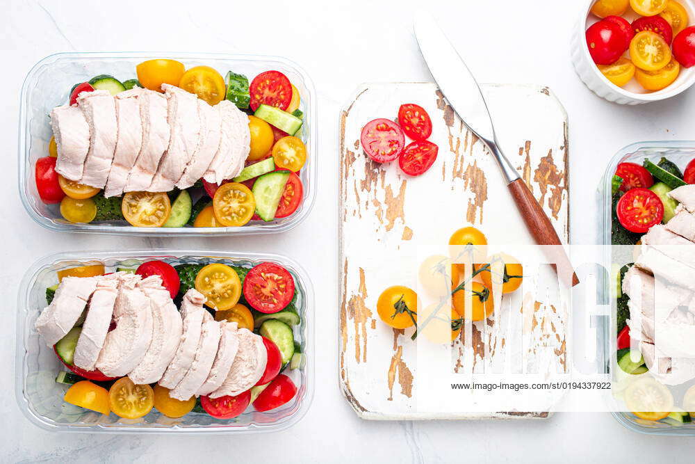 Meal prep lunch boxes containers with chicken and salad top view