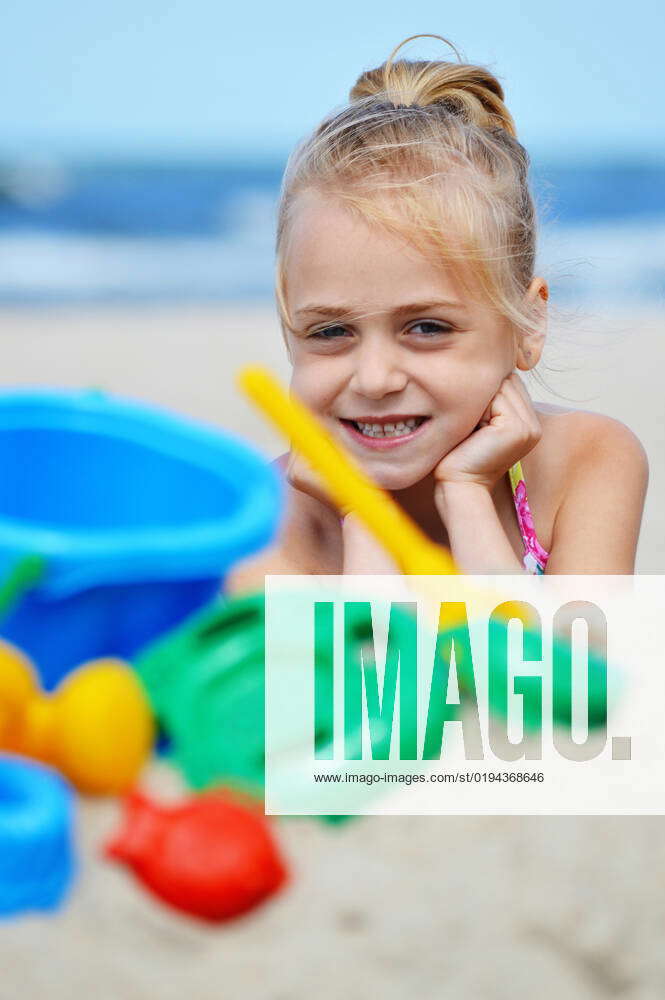 Little girl playing on the sand beach. Little girl playing on the sand