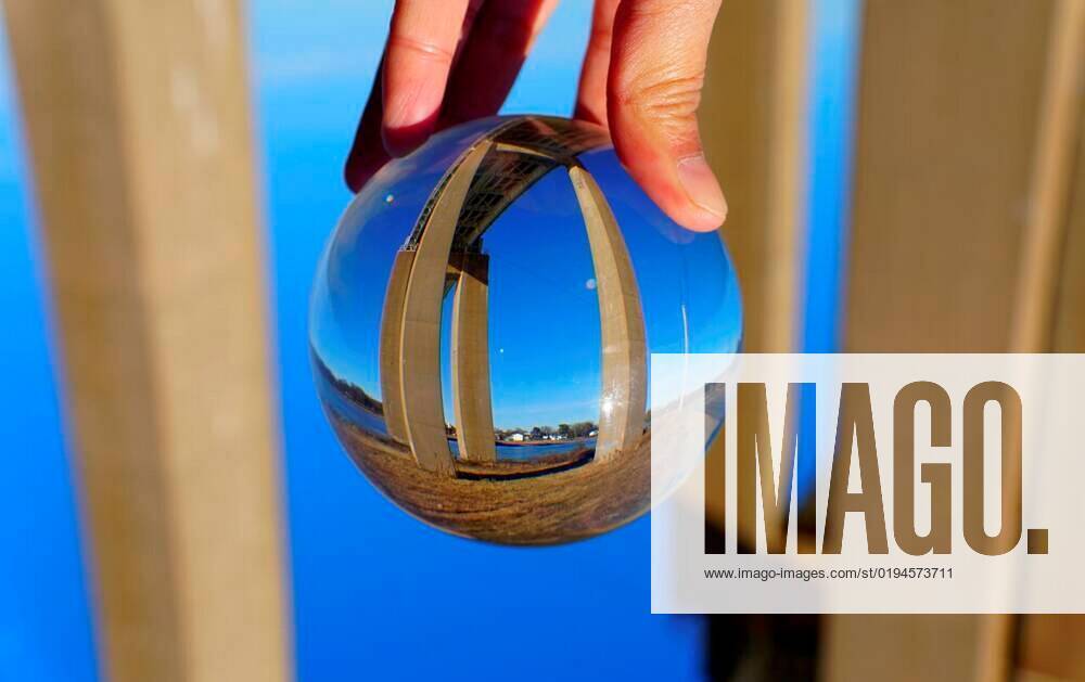 The view of William V Roth Bridge captured through a crystal lens ball