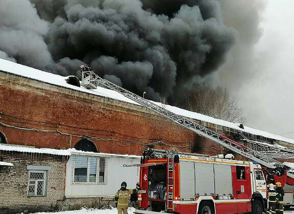 Russian Firefighter Rural RUSSIA, MOSCOW - : Firefighters battle a fire at a storage facility ...